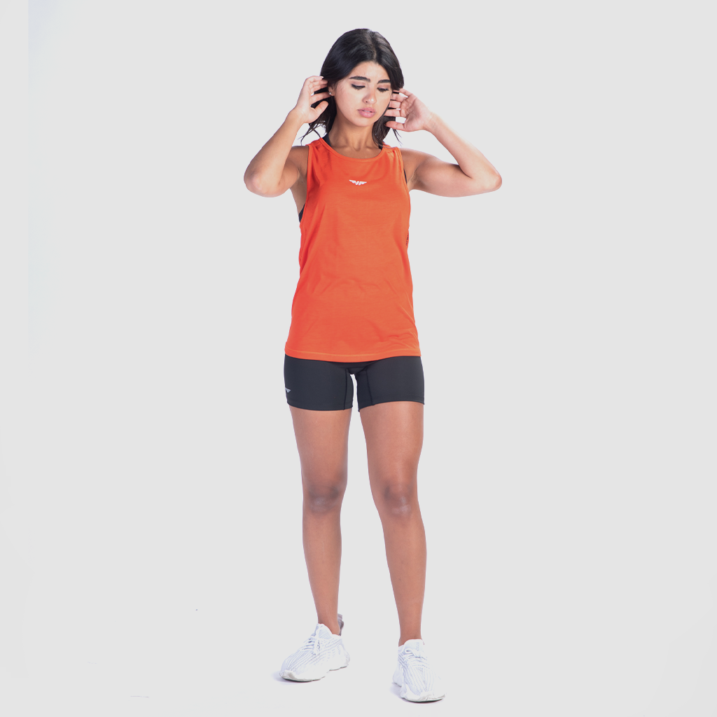 a fit woman wearing tank orange with bras and short ,matching color black, plus  sneakers white 