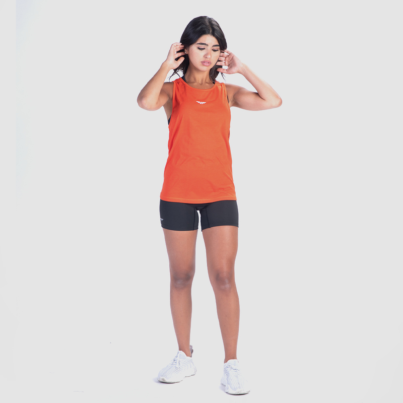 a fit woman wearing tank orange with bras and short ,matching color black, plus  sneakers white 