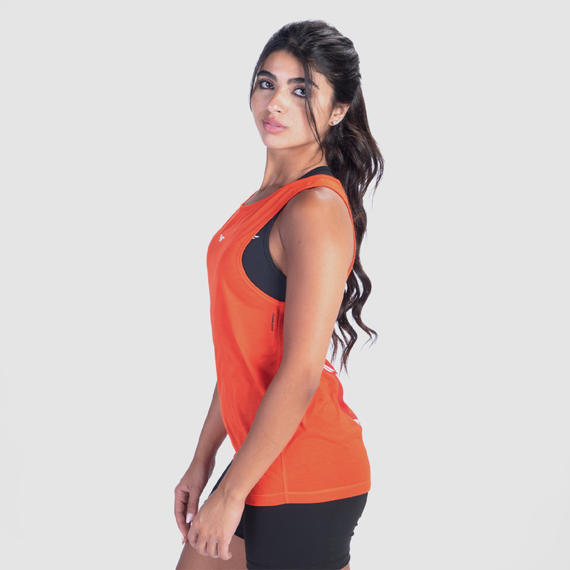 a fit woman stand at right and wearing tank  orange with short black 