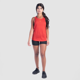 a fit woman wearing tank red with  short black  and sneakers 