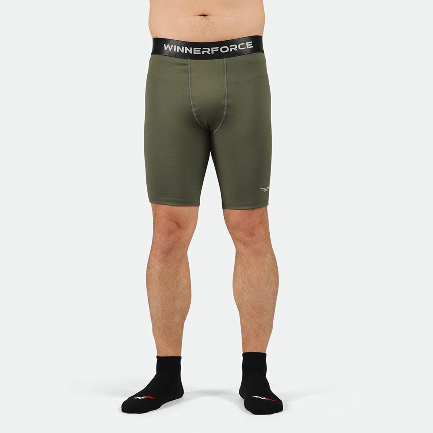A pair of green, firm shorts designed for men, featuring a branded elastic waistband and a reflective logo on the side.