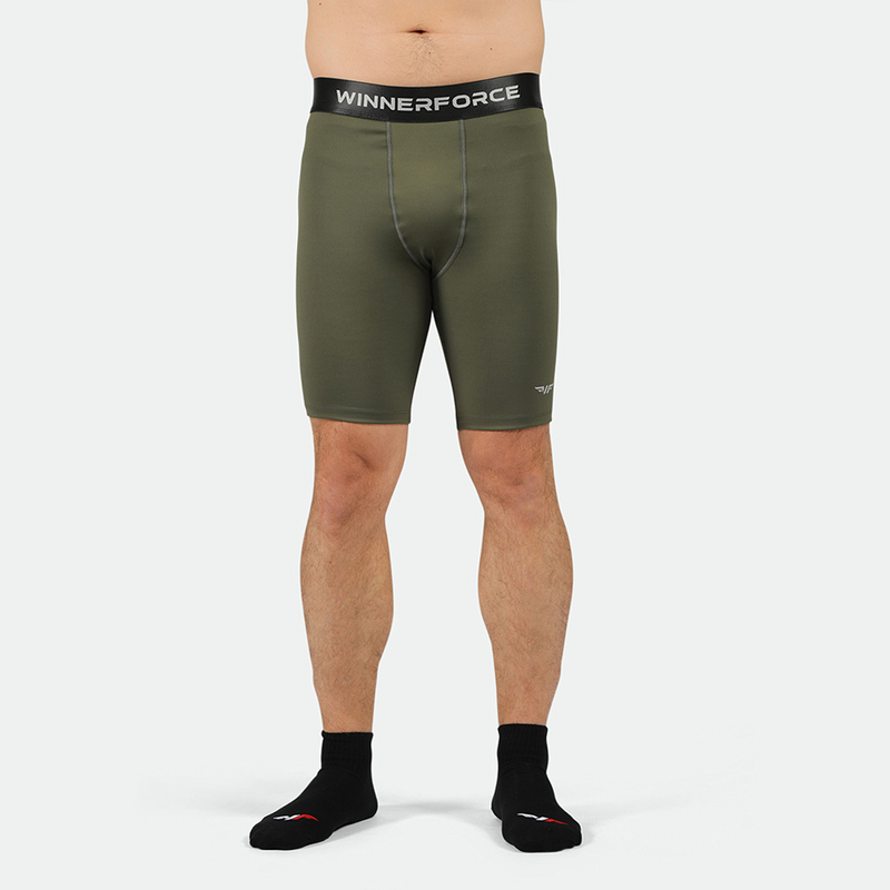 A pair of green, firm shorts designed for men, featuring a branded elastic waistband and a reflective logo on the side.