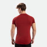 a back view for fit man wearing t-shirt  tomato dark red  with pants black 