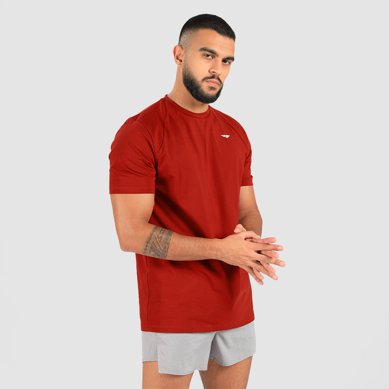a fit man wearing t-shirt tomato dark red with short grey  