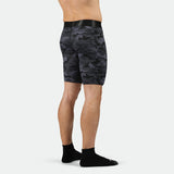 a back view for fit man wearing short 
 grey toned camo with socks black 