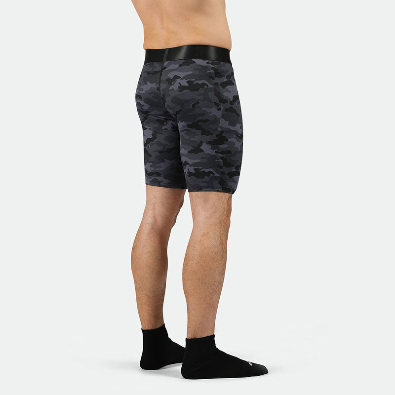 a back view for fit man wearing short 
 grey toned camo with socks black 