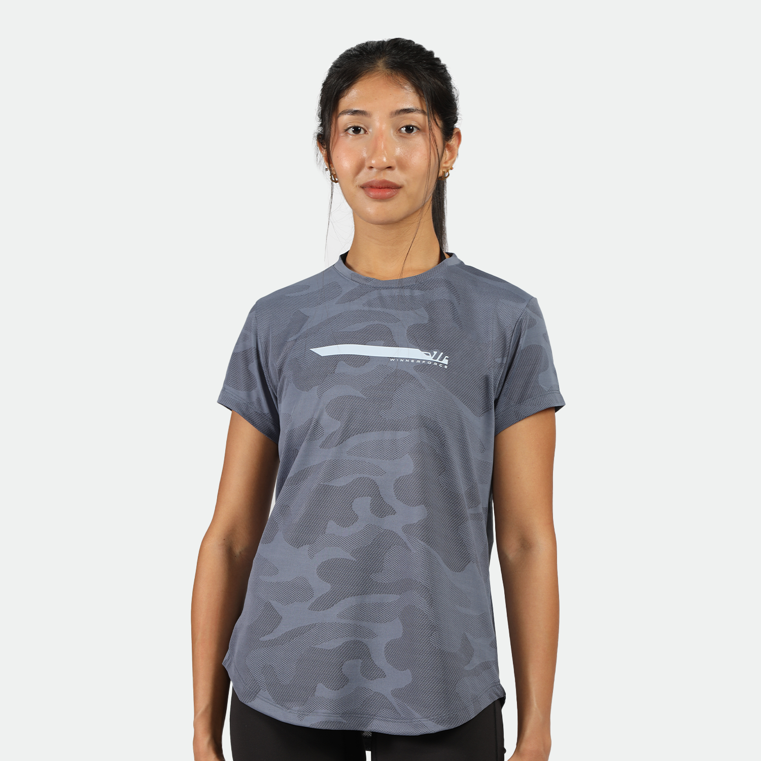 a fit woman look at the camera and wearing camo t-shirt blue with legging  black 