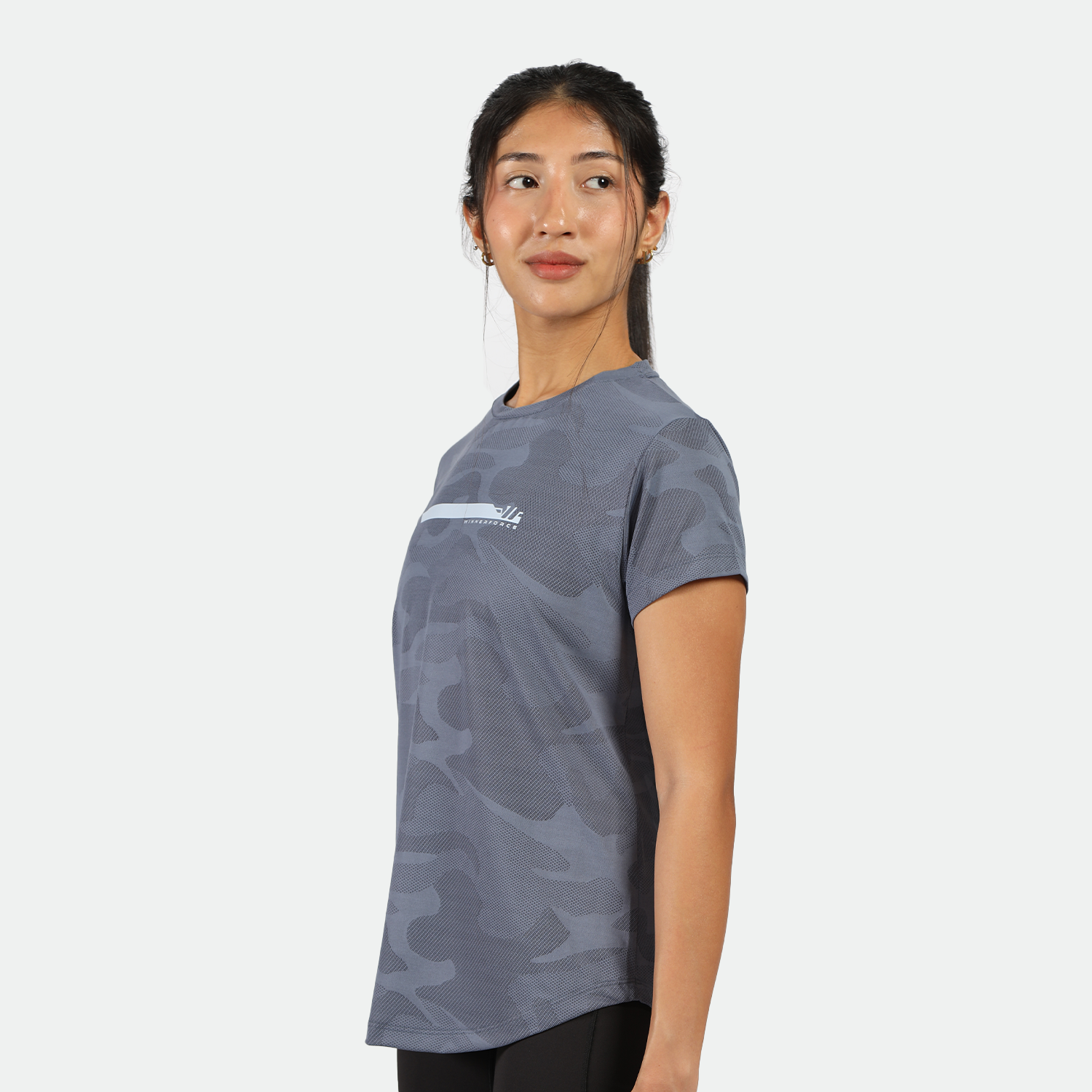 a fit woman stand at right and wearing  camo t-shirt blue with legging black 