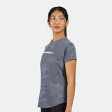 a fit woman stand at right and wearing  camo t-shirt blue with legging black 