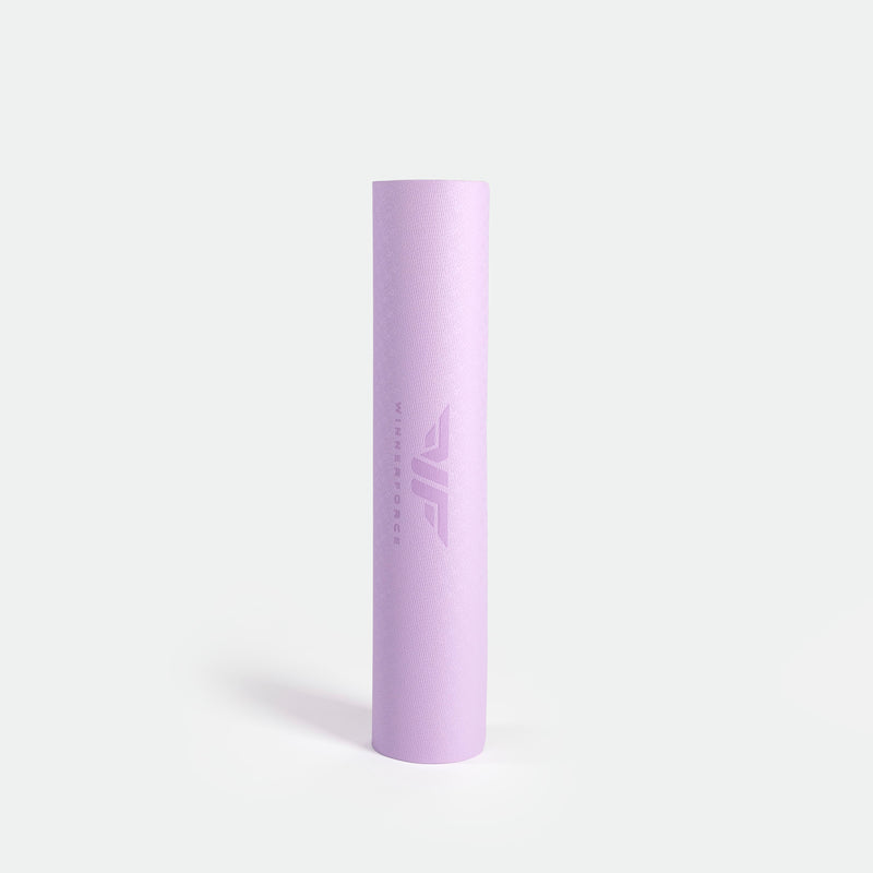 A rolled-up lavender yoga mat on a white background. The mat has a smooth texture with a subtle, embossed logo near the center, conveying calmness and simplicity.
