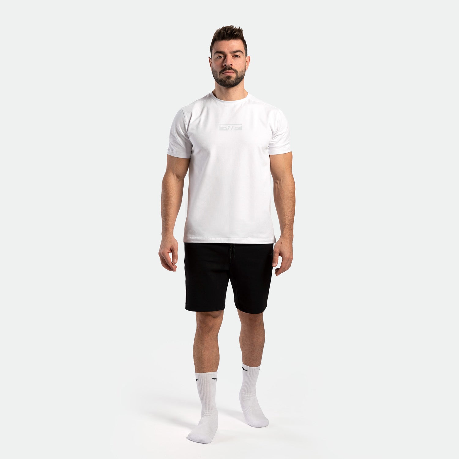 a fit man wearing t-shirt white with short black ,plus socks white 