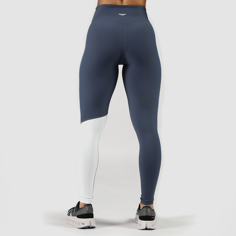 a back view for fit woman wearing  legging   mix tow color blue and white with logo in half ,plus she wearing sneakers 