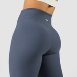 close up view for fit woman wearing  wearing legging blue with logo in half 