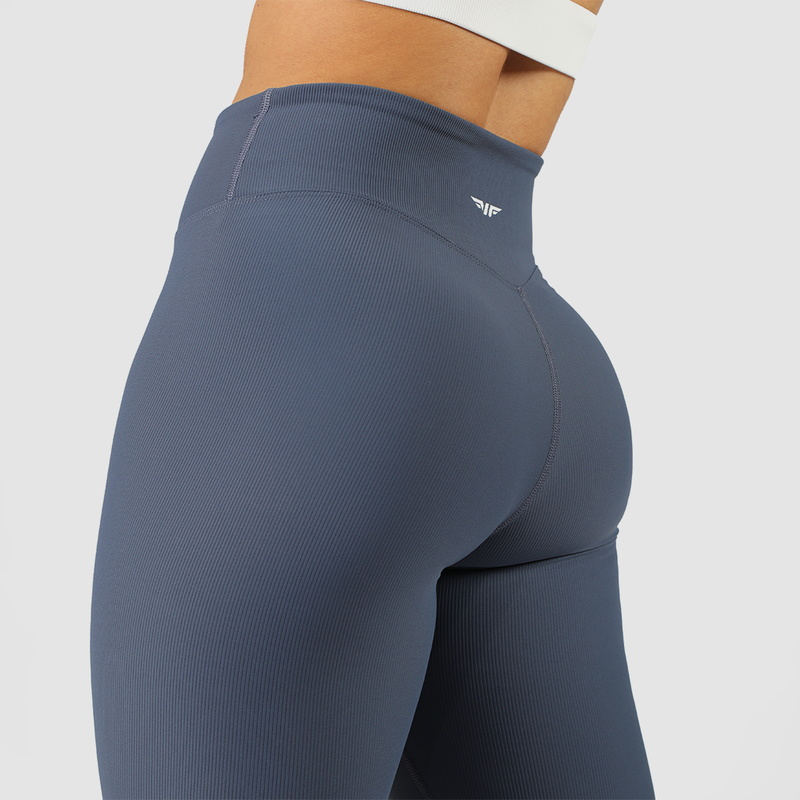 close up view for fit woman wearing  wearing legging blue with logo in half 