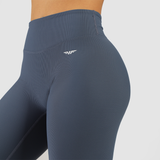 close up view for fit woman wearing legging blue with logo in sides 