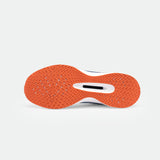 Orange sneaker sole with a herringbone pattern and a white midsole visible against a light gray background. The design suggests grip and style.