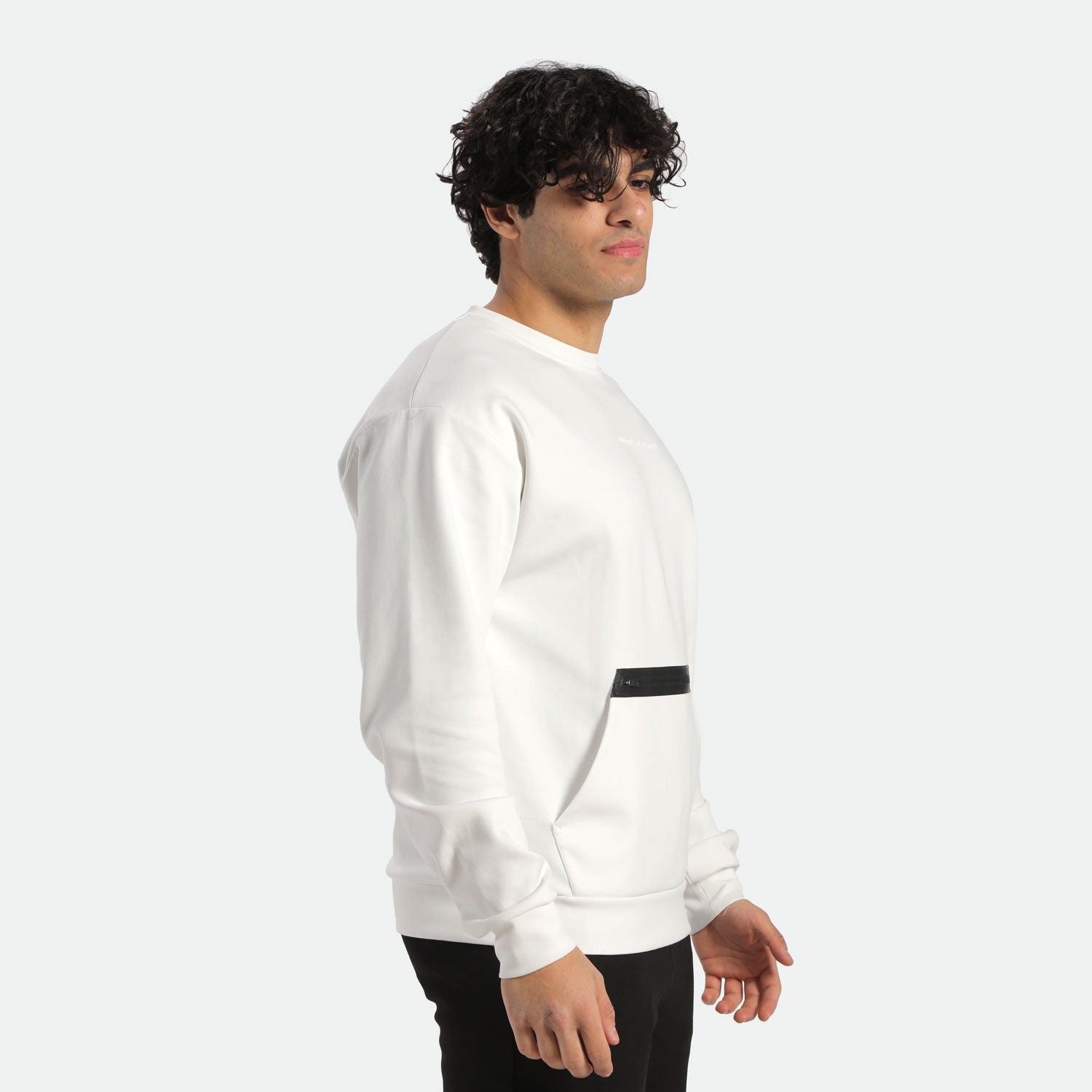 a fit man stand at right and wearing sweatshirt  white with pants black 