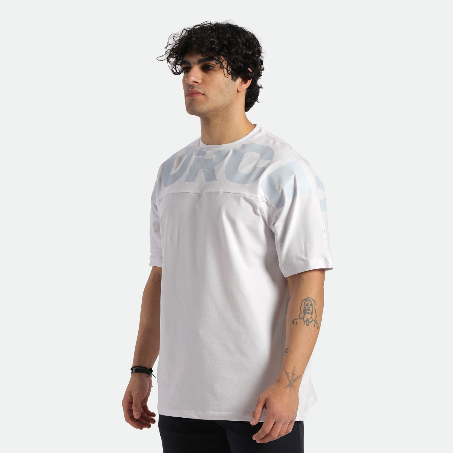 a  fit man stand at right ad wearing t-shirt white with pants black 
