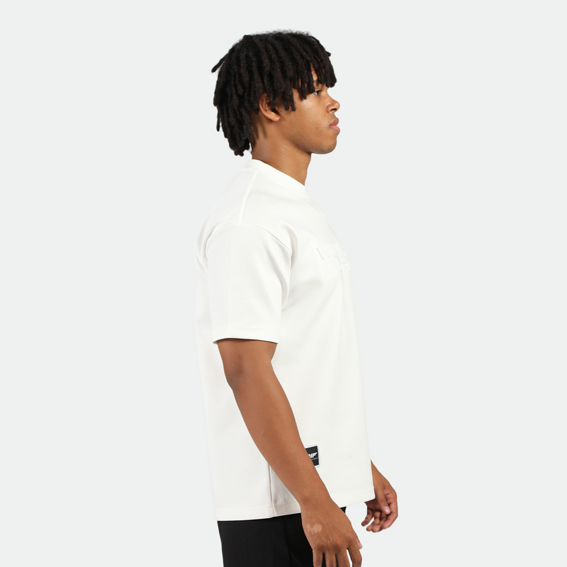 a fit man stand at right and wearing t-shirt white with short black 