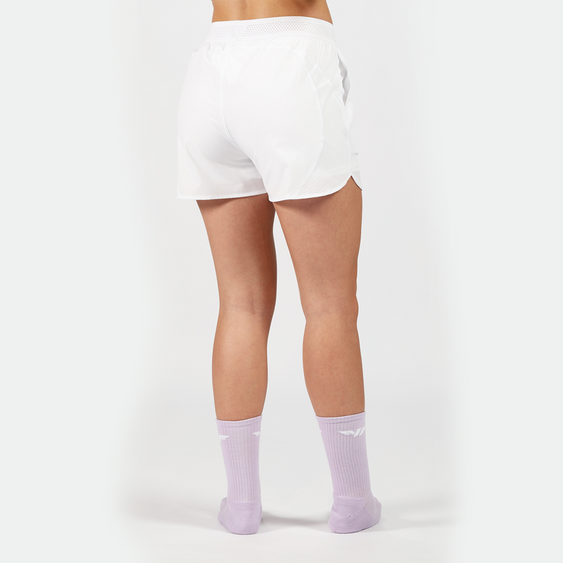a back view for fit woman wearing short white 2 in 1 with socks purpel ,plus the background is light grey 