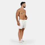 a fit man stand at right and wearing short white with socks 