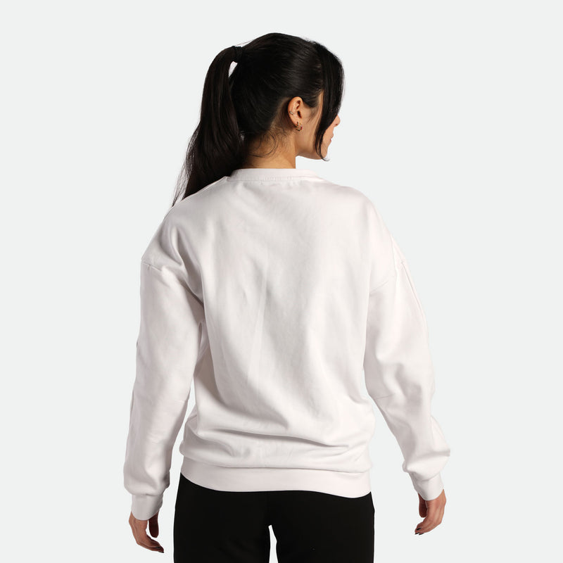 A young woman with a ponytail wearing a white sweatshirt, facing away from the camera, showcasing the back of the garment.