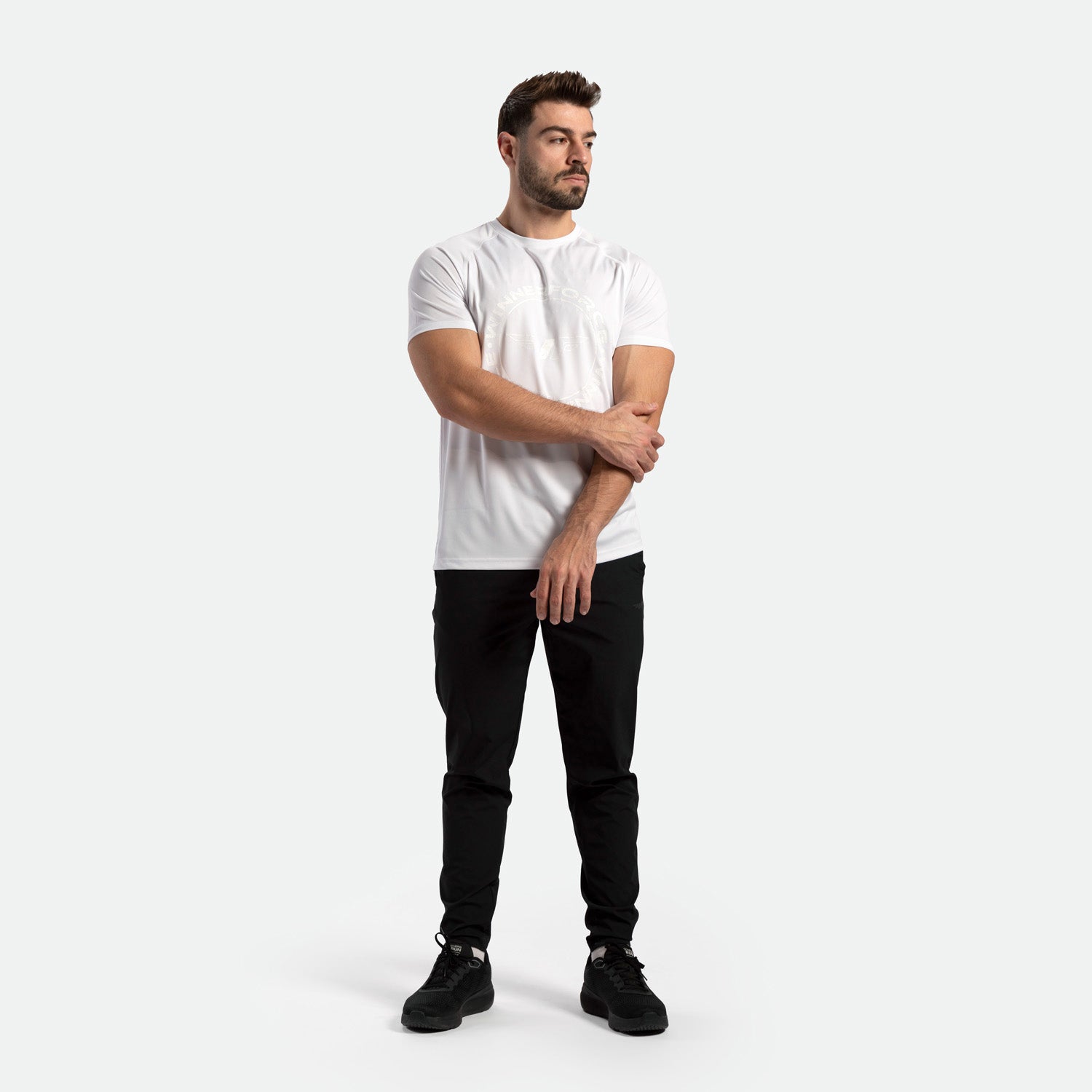 a fit man wearing t-shirt white with pants black and shoes 