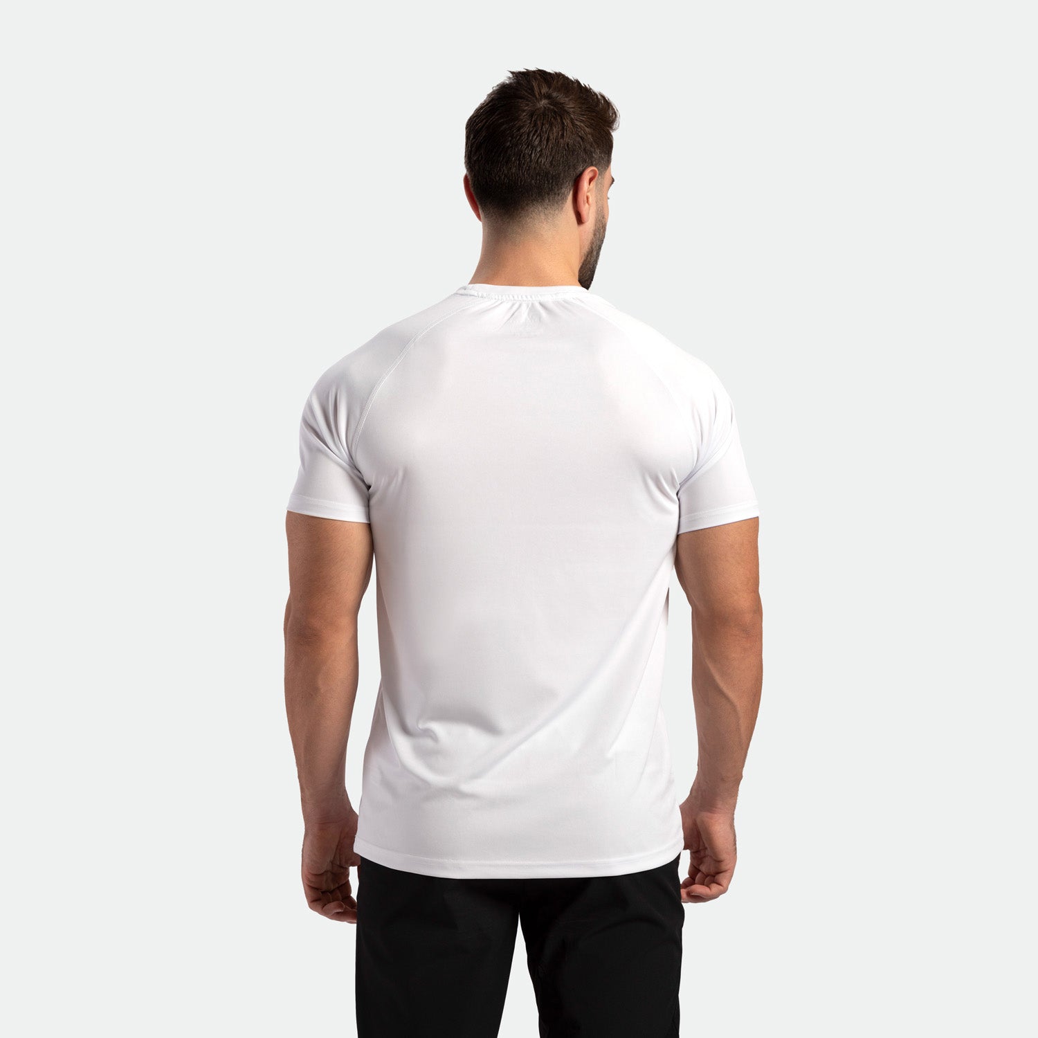 a back view for fit man wearing t-shirt white with pants black 