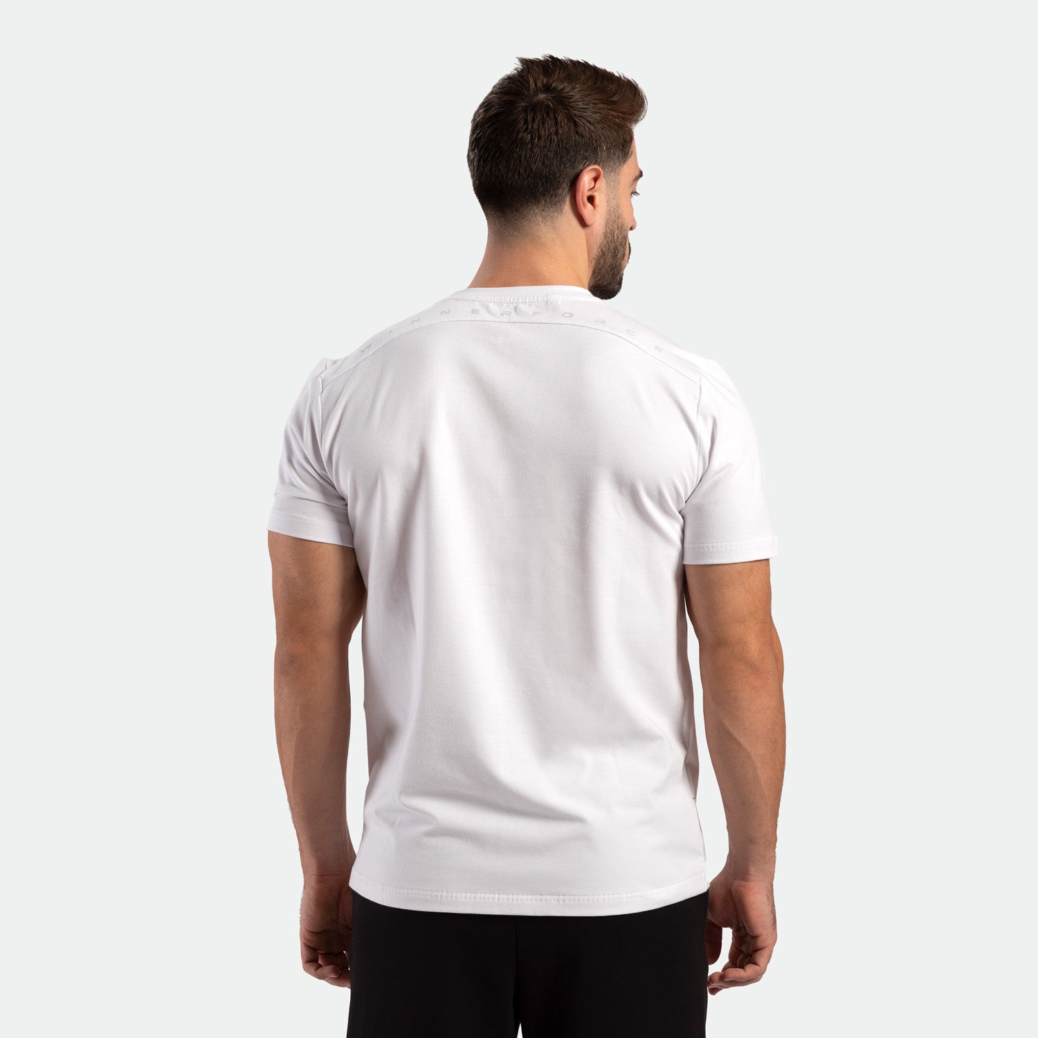 a back view for fit man wearing t-shirt  white with pants black 