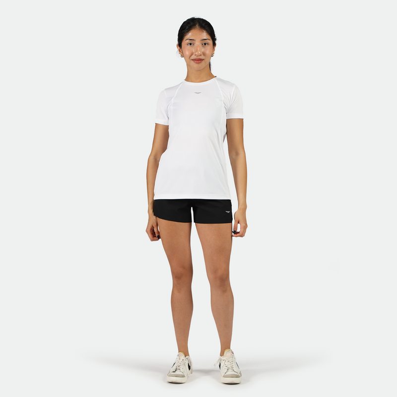  a fit woman look at the camera with smile, she wearing white t-shirt with black short and sneakers 