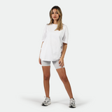 a fit woman wearing t-shirt white with short grey and sneakers 