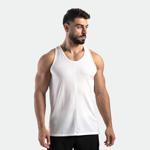 A male model wearing a white sleeveless tank top.