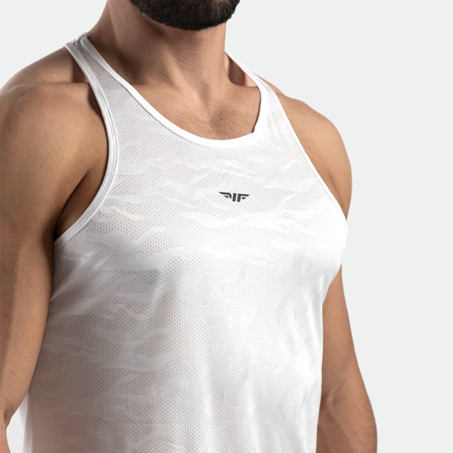 close up view for fit man wearing tank white with logo in half 