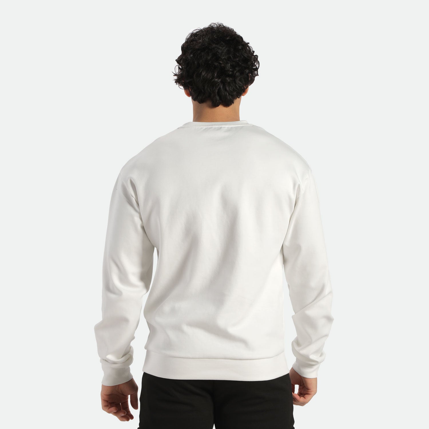 a back view for fit man wearing sweatshirt white and pants black 