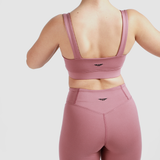 Back view of woman wearing matching bra and short , same logo, with light grey background