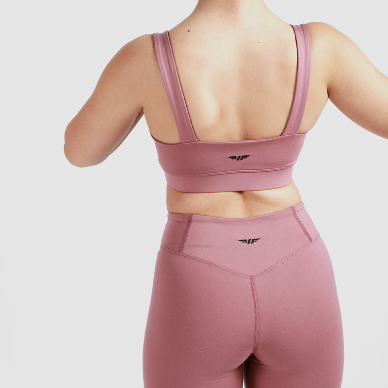 Back view of woman wearing matching bra and short , same logo, with light grey background