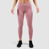 a fit woman wearing legging pink and shoes black ,the background is light grey 