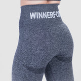 a back view for woman wearing  legging grey with bag logo ,the background is light grey 