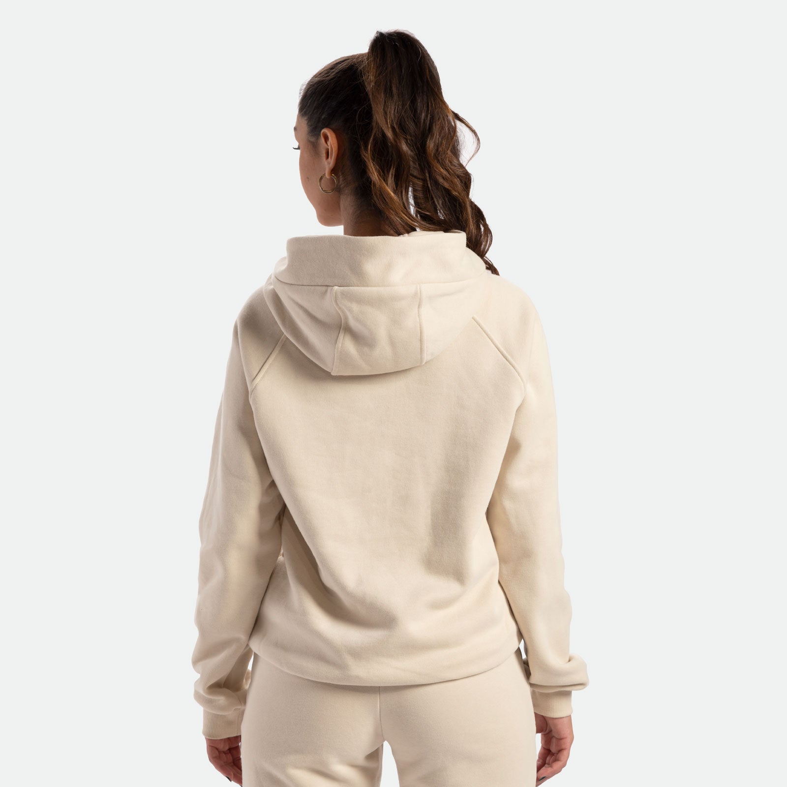 a back view for fit woman wearing hoodie beige with pants 