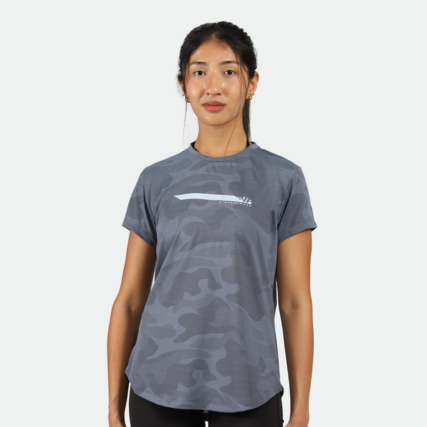 a fit woman look at the camera and wearing camo t-shirt blue with legging  black 