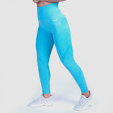 a fit woman stand at right and wearing legging blue with logo white ,plus shoes white ,the background is light grey 