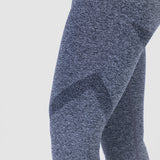 a woman wearing legging  grey with background light grey 