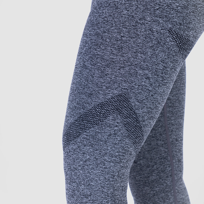 a woman wearing legging  grey with background light grey 