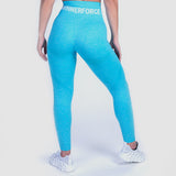  a back view for woman wearing legging  blue with bag logo white ,and she wearing  shoes white ,the background  is light grey 