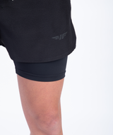 close up view for fit man wearing short 2 in 1 black with logo 