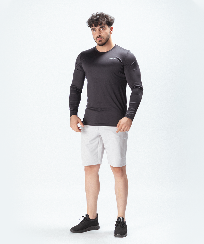 a fit man wearing t-shirt sleeve grey with logo and short white ,plus shoes black 