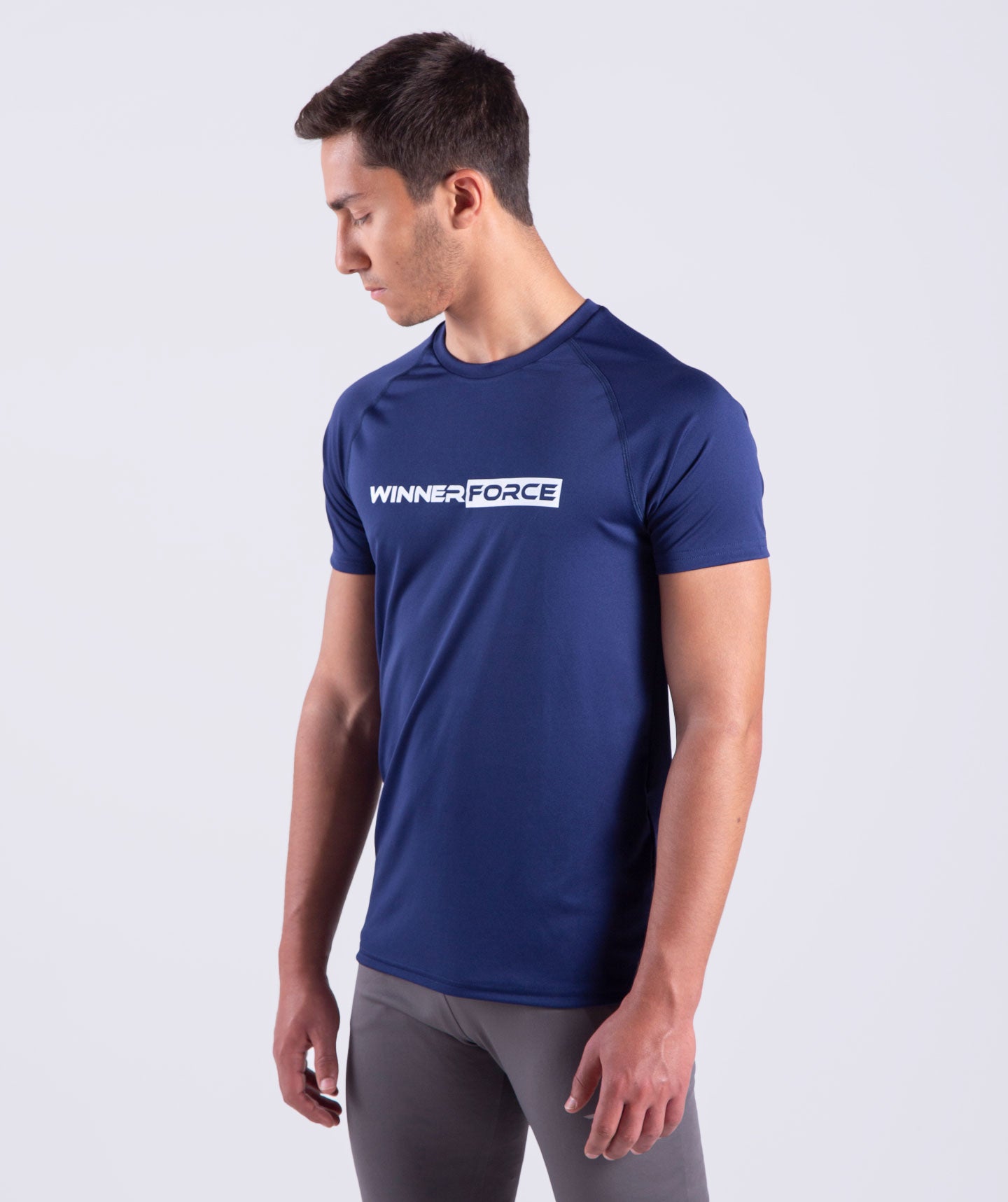 a fit man wearing t-shirt navy blue with pants grey 